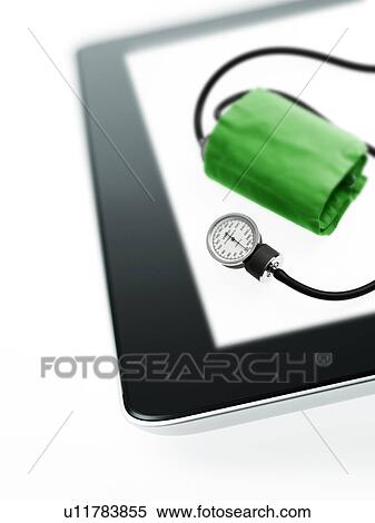 Stock Photography - Studio shot of blood pressure gauge on digital tablet. Fotosearch