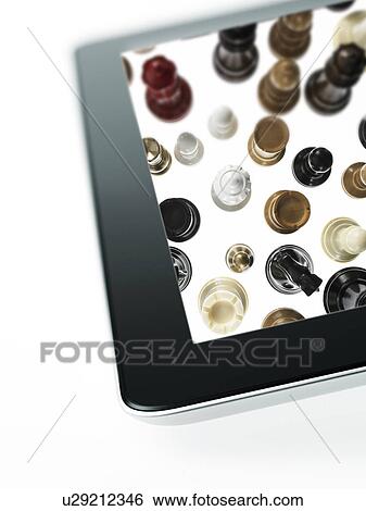 Stock Photograph - Studio shot of chess pieces on digital tablet. Fotosearch