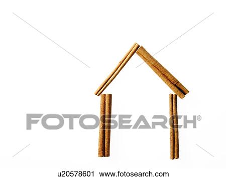 Stock Image - Studio shot of Cinnamon Sticks making House shape on white background. Fotosearch