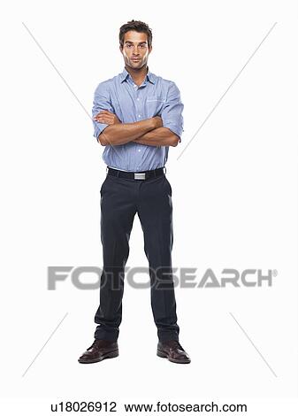 Studio shot of confident business man standing with hands folded View Large Photo Image Stock Image - Studio shot of confident business man standing with hands folded. Fotosearch