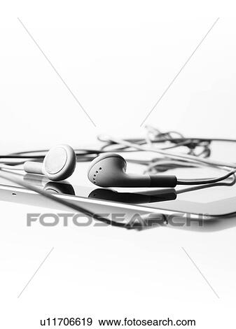 Stock Photo - Studio shot of digital tablet and earphones. Fotosearch