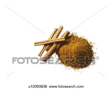 Stock Photo - Studio shot of Ground Cinnamon and Cinnamon Sticks on white background. Fotosearch