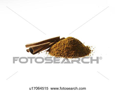 Stock Photography - Studio shot of Ground Cinnamon and Cinnamon Sticks on white background. Fotosearch