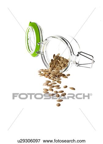 Stock Photo - Studio shot of jar with Pumpkin Seeds on white background. Fotosearch