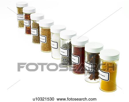 Stock Image - Studio shot of Jars with spices on white background. Fotosearch
