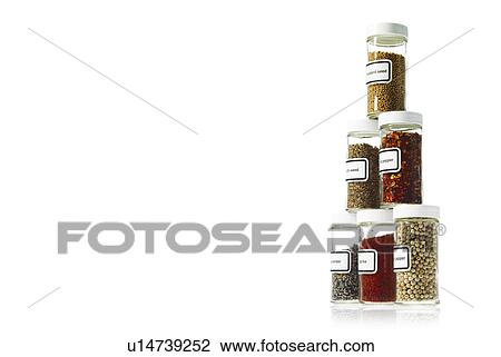 Stock Image - Studio shot of Jars with spices on white background. Fotosearch