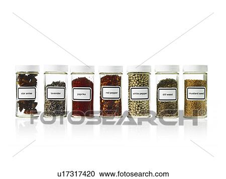 Stock Image - Studio shot of Jars with spices on white background. Fotosearch