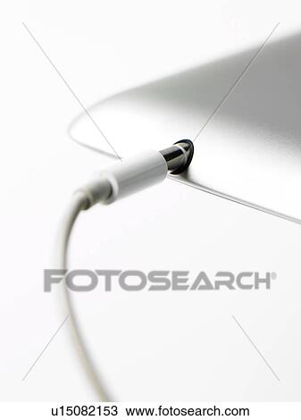 Stock Image - Studio shot of mobile phone with charger. Fotosearch