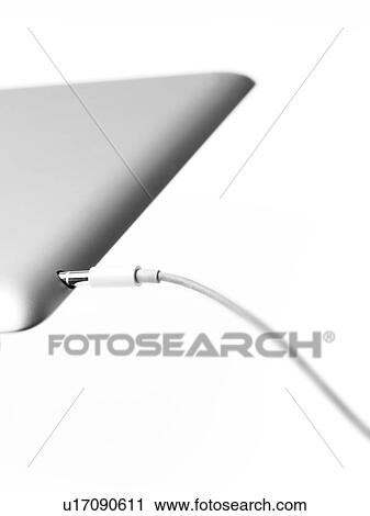 Stock Image - Studio shot of mobile phone with charger. Fotosearch