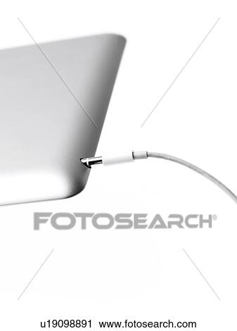 Stock Image - Studio shot of mobile phone with charger. Fotosearch