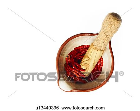 Stock Photograph - Studio shot of Mortar and Pestle with Red Chili Peppers on white background. Fotosearch