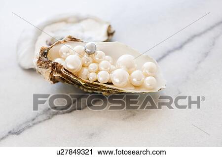 Stock Image - Studio shot of pearls in oyster. Fotosearch