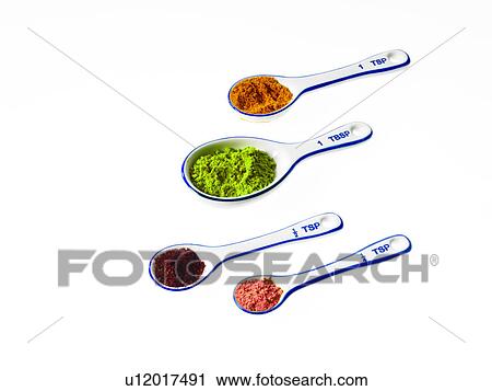 Stock Image - Studio shot of piles of spices on measuring spoons. Fotosearch