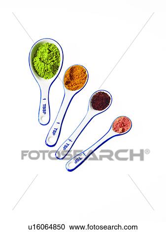 Stock Image - Studio shot of piles of spices on measuring spoons. Fotosearch