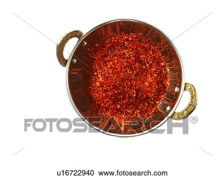 Stock Image - Studio shot of Red Chili Flakes in pan on white background. Fotosearch
