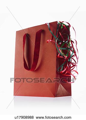 Studio shot of red gift bag with ribbons View Large Photo Image Stock Photo - Studio shot of red gift bag with ribbons. Fotosearch