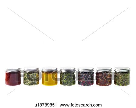 Stock Image - Studio shot of row of jars with spices. Fotosearch