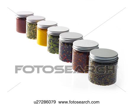 Stock Photo - Studio shot of row of jars with spices. Fotosearch