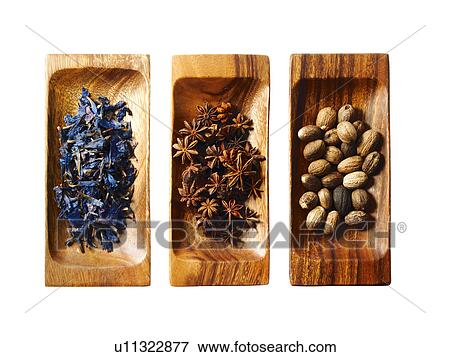 Stock Photo - Studio shot of star anise, nutmeg and lavender on wooden trays. Fotosearch