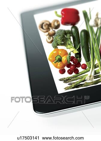 Stock Image - Studio shot of various vegetables on digital tablet. Fotosearch