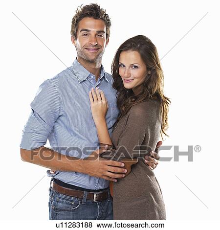Stock Photo - Studio shot of young attractive couple smiling. Fotosearch
