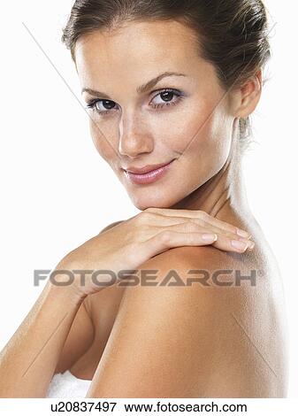 Studio shot of young attractive woman with hand on shoulder View Large Photo Image Stock Photo - Studio shot of young attractive woman with hand on shoulder. Fotosearch