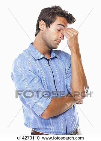 Studio shot of young business man with eyes closed rubbing nose View Large Photo Image Stock Image - Studio shot of young business man with eyes closed rubbing nose. Fotosearch