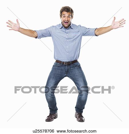 Stock Photograph - Studio shot of young cheerful man with arms outstretched. Fotosearch