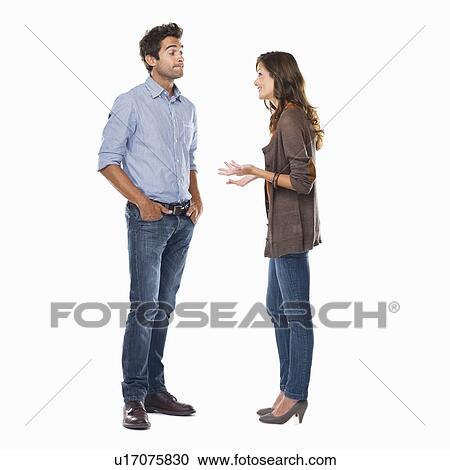 Studio shot of young couple having conversation View Large Photo Image Stock Image - Studio shot of young couple having conversation. Fotosearch