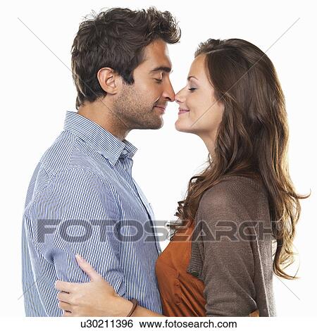 Stock Photograph - Studio shot of young couple rubbing noses. Fotosearch