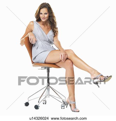 Studio shot of young pretty woman sitting on chair View Large Photo Image Picture - Studio shot of young pretty woman sitting on chair. Fotosearch