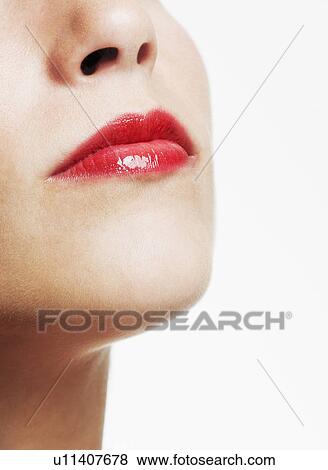 Stock Photo - Studio shot of young woman wearing red lipstick. Fotosearch