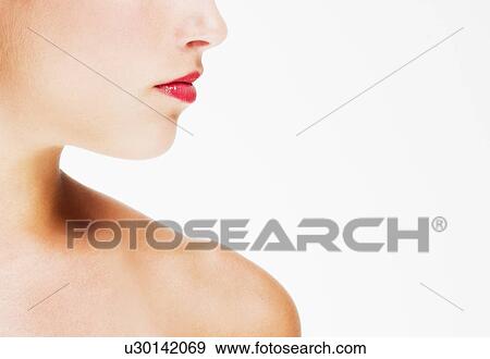 Stock Photo - Studio shot of young woman wearing red lipstick. Fotosearch