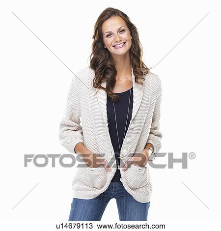 Studio shot of young woman with hands in pockets and smiling View Large Photo Image Stock Image - Studio shot of young woman with hands in pockets and smiling. Fotosearch