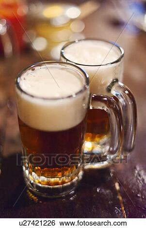 Stock Photograph - Two beers on bar. Fotosearch