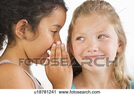 Two girls (8-9) whispering View Large Photo Image Stock Image - Two girls (8-9) whispering. Fotosearch