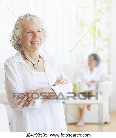 Two senior women in living room View Large Photo Image Stock Photography - Two senior women in living room. Fotosearch