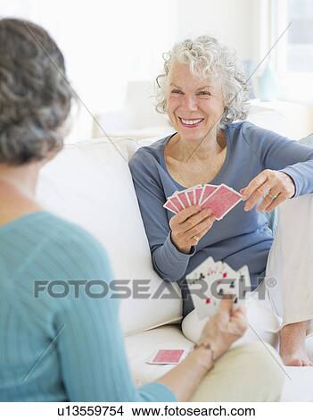 Picture - Two senior women playing cards. Fotosearch
