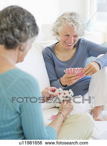 Two senior women playing cards View Large Photo Image Stock Photograph - Two senior women playing cards. Fotosearch