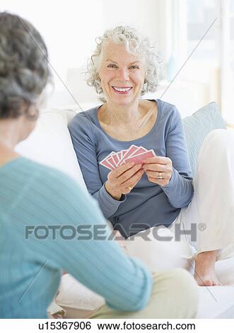 Two senior women playing cards View Large Photo Image Stock Photograph - Two senior women playing cards. Fotosearch