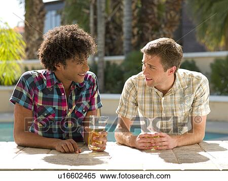 Stock Photography - USA, Arizona, Scottsdale, Two men at hotel bar enjoying drink. Fotosearch