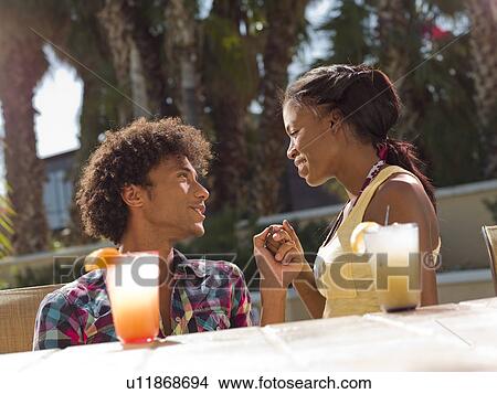 Picture - USA, Arizona, Scottsdale, Young couple at pool side bar. Fotosearch