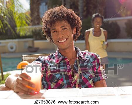 Stock Photograph - USA, Arizona, Scottsdale, Young couple at pool side bar. Fotosearch