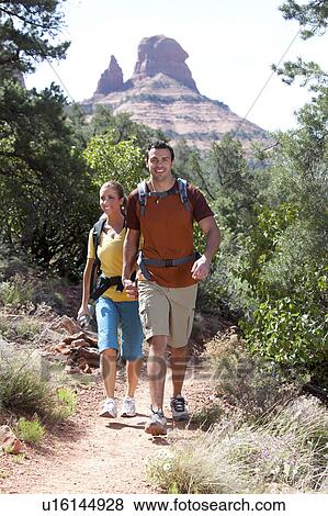 Stock Photo - USA, Arizona, Sedona, Young couple hiking. Fotosearch