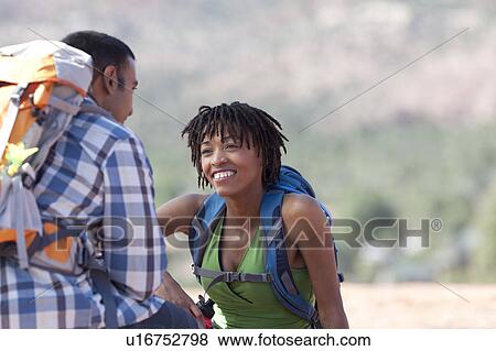 Stock Photo - USA, Arizona, Sedona, Young couple hiking and enjoying desert scenery. Fotosearch