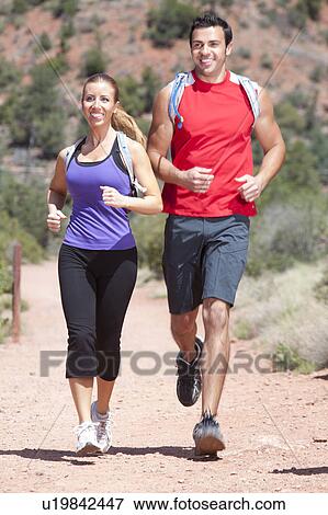 USA, Arizona, Sedona, Young couple running in desert View Large Photo Image Stock Photo - USA, Arizona, Sedona, Young couple running in desert. Fotosearch