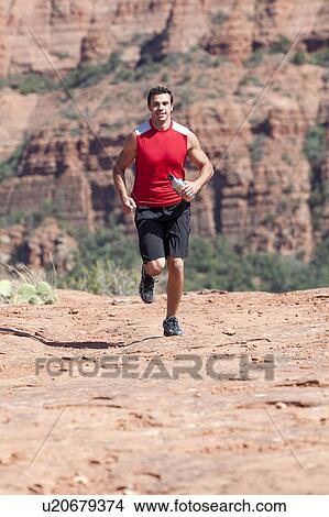 USA, Arizona, Sedona, Young man running in desert View Large Photo Image Picture - USA, Arizona, Sedona, Young man running in desert. Fotosearch