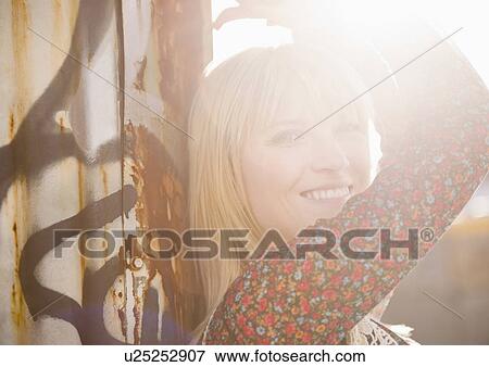 Stock Photo - USA, Brooklyn, Williamsburg, Portrait of blonde woman in backlit. Fotosearch