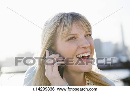 USA, Brooklyn, Williamsburg, Portrait of blonde woman talking on mobile phone View Large Photo Image Stock Photograph - USA, Brooklyn, Williamsburg, Portrait of blonde woman talking on mobile phone. Fotosearch