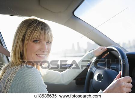 USA, Brooklyn, Williamsburg, Portrait of blonde woman driving car View Large Photo Image Stock Photography - USA, Brooklyn, Williamsburg, Portrait of blonde woman driving car. Fotosearch